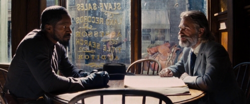 Picture of the 2 leads (Foxx and Waltz) at a table in a town
